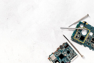 Electronics circuit board with microchips and tools, top view