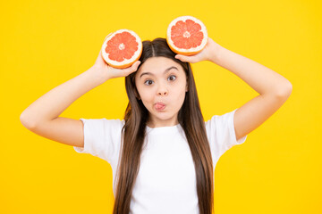 Funny face. Happy teenager girl in t-shirt hold grapefruit orange, kids fruits vitamin.
