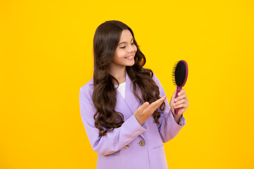 Teen girl girl with brush combing hair. Girl taking haircare and hairstyle. Hairdresser hair solon for teenager. Happy face, positive and smiling emotions of teenager girl.