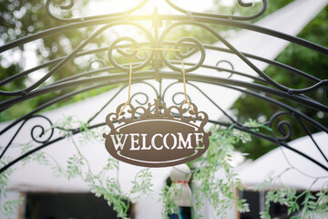 vintage welcome sign hanging on arched entrance