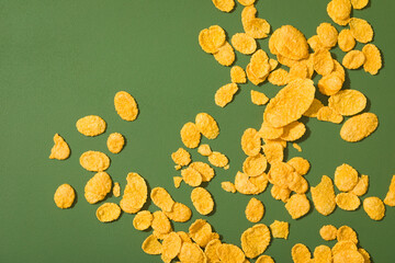scattered corn flakes on a green table