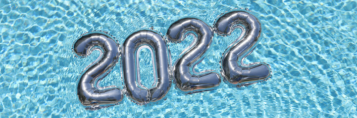 Helium balloons with numbers 2022 lying on water in swimming pool top view closeup background
