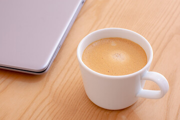 cup of coffee and laptop on the table