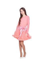 Beautiful girl in pink dress posing on white background