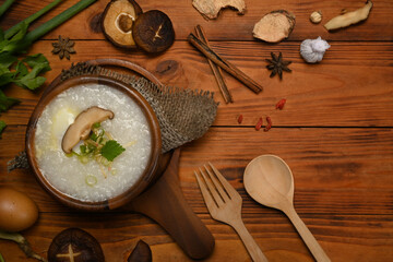 Vegetarian rice porridge with soft boiled egg, shiitake mushroom, slice ginger and slice scallion for light meal. Top view