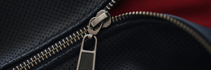 Closeup of zipper on blue leather jacket © H_Ko