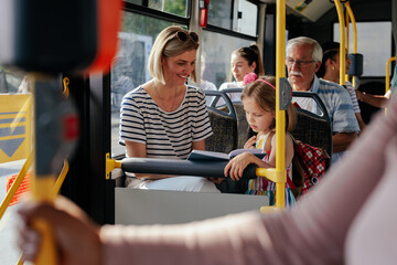 Mom and daughter riding bus - obrazy, fototapety, plakaty
