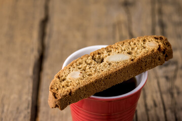 Red Mug of Strong Coffee Served with Italian Almond Cookies Cantucci Old Wooden Background Copy...