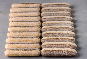 Lady Fingers Cookies (savoyardi) for Cooking Tiramisu Ingredient for Traditional Italian Dessert Crispy Biscuits Grey background