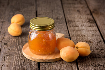 Jar of Apricot Jam on Wooden Cutting Board Homemade Raw Apricot Horizontal