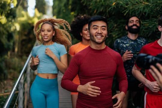 Multiracial runners with smiles on their faces exercising outdoor