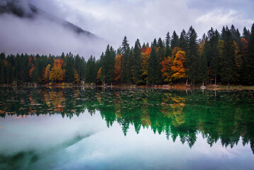Fototapeta premium Beautiful autumn gloomy scenery by the lake