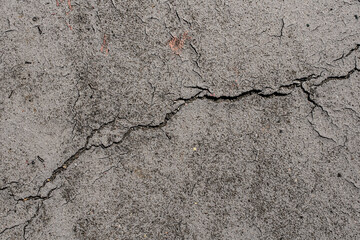 asphalt in cracks texture / abstract background cracks on asphalt road. Damaged and cracked asphalt ground background. Abstract aged road pattern detail.. Crack concrete texture surface background.  