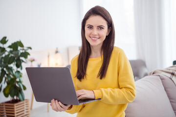 Portrait of charming cheerful lady toothy smile hold wireless netbook house indoors