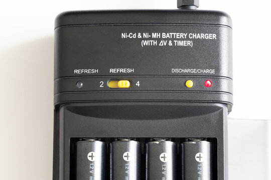 Charge And Discharge Adapter Of Nickel Cadmium And Nickel Magnesium Batteries. AA Batteries Are Charging.