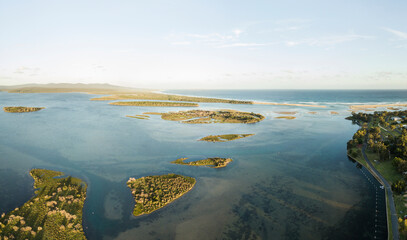 Aerial view over islands in the Mallacoota Inlet near the mouth of the Wallagaraugh River at sunset, eastern Victoria, Australia, December 2020.