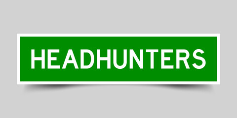 Sticker label with word headhunters in green color on gray background