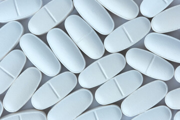 White pills view from above medical background.