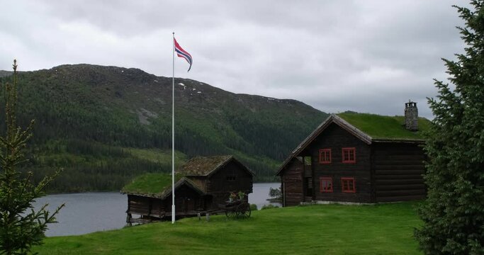 Wonderful landscapes in Norway. Aust Agder. Beautiful scenery of houses with grass roof. Norwegian traditional architecture Mountains, trees and snow in background 4K UHD 59,94fps ProRes 422 HQ 10 bit