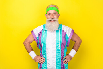 Photo of cheerful funky granddad put hands waist wear condensed milk color sport suit isolated on yellow background