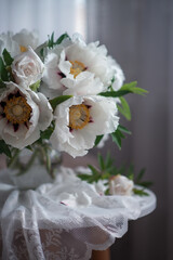 Still-life. A bouquet of white peonies on the table.