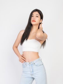 Portrait of a beautiful sexy young asian female long hair lady in white color tube top fashion, good for cosmetic and skincare or barber ads