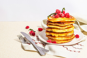 Classic homemade American pancakes with frozen raspberries, hazelnut and mint. Healthy breakfast
