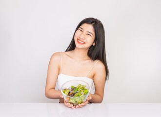 Portrait photo of a young beautiful asian female lady with a bowl of mixed salad in her hand. Good for healthy, fitness or dietary meal and restaurant advertisement or promotion.