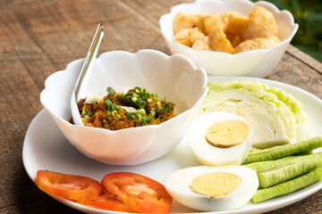 Thai minced pork chili paste with boiled egg and fresh vegetables