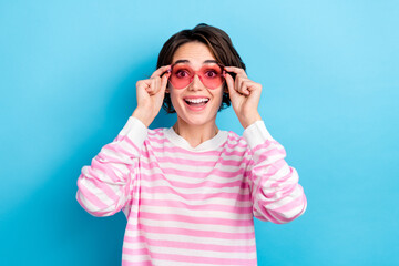 Portrait of happy excited cheerful woman in heart shape glasses see black friday bargain isolated...