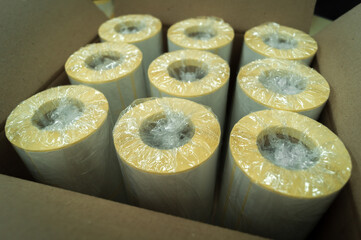 Packed in a cardboard box rollers of white self-adhesive labels for product marking. Rolls of...