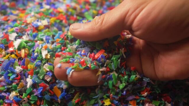 microplastics in hands. colorful plastic fragments or particles, toxic chemicals, environment, water pollution. pieces of microplastic in the world's oceans. plastic recycling concept