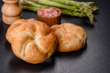 Crusty round bread rolls, known as Kaiser or Vienna rolls on a cutting board