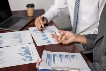 Two business leaders talk about charts, financial graphs showing results are analyzing and calculating planning strategies, business success building processes