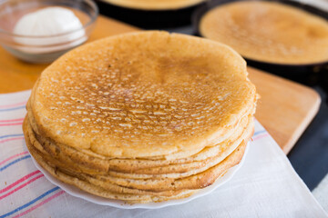 cooking traditional pancakes from wheat flour in the kitchen