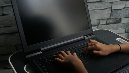 person typing on a laptop