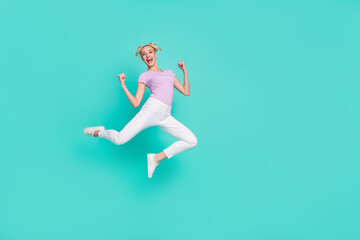 Fototapeta na wymiar Full length body size view of attractive cheerful lucky girl jumping rejoicing having fun isolated over teal turquoise color background