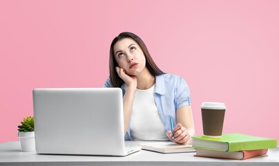 Fototapeta premium Young women stress from overwork on a pastel pink background.