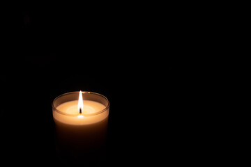 Candle in the dark black background