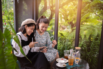 Fototapeta premium Girls drink coffee relax in cafe ,Freelancer communicate on project, girls shopping online on wifi tablet,Students studies on internet,Working business process.