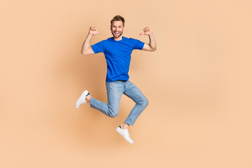 Fototapeta na wymiar Full length photo of young excited man indicate fingers himself cool choose jumper energetic isolated over beige color background