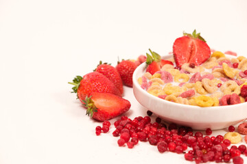 Quick breakfast of cereals and rings of corn and wheat with strawberries and lingonberries, place for text