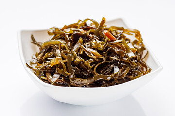 seaweed salad on a white acrylic background