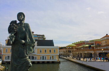 Bronze statue of woman on the canal bridge in Aveiro