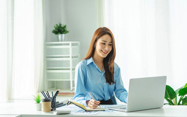 Portrait of smiling beautiful business asian woman working in office use computer with copy space. Business owner people sme freelance online marketing e-commerce telemarketing