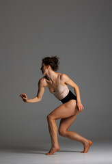 Young beautiful yoga female is exercising in classroom