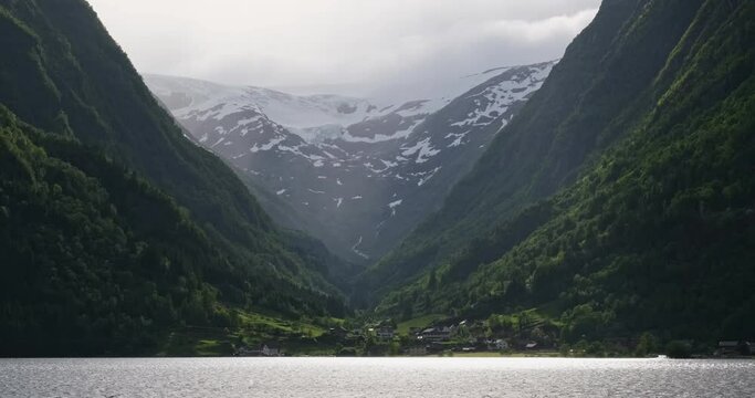 Wonderful landscapes in Norway. Vestland. Beautiful scenery of Buerbreen glacier. Sandvevatnet lake. Mountains, trees, rocks and houses in background. 4K UHD 59,94fps ProRes 422 HQ 10 bit