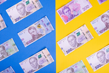 hryvnia banknotes on the background of the Ukrainian flag. flat ley pettern. the concept of poverty in the country