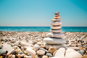 Rocky beach. Blue Sea. Turret of stones. Summer, vacation.