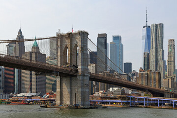 Famous Brooklyn Bridge (1883), hybrid cable-stayed, suspension bridge, in background of New York skyscrapers and Towers